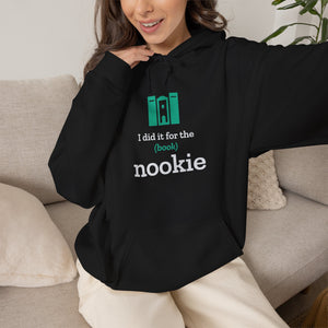 Woman on a couch wearing the black Nook & Things bookish hoodie