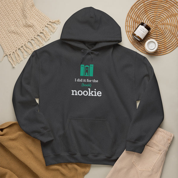 Dark heather grey Nook & Things hoodie styled flat with a blanket and candle