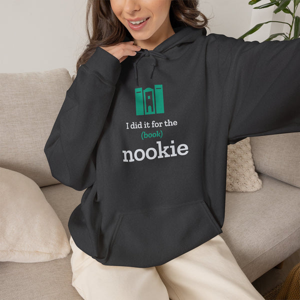 Woman on a couch wearing the dark heather grey Nook & Things hoodie