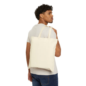 Natural canvas tote bag worn over the shoulder, showing the 15 by 16 inch size