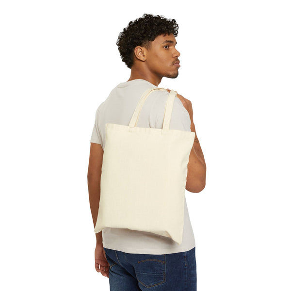 Natural canvas tote bag worn over the shoulder, showing the 15 by 16 inch size