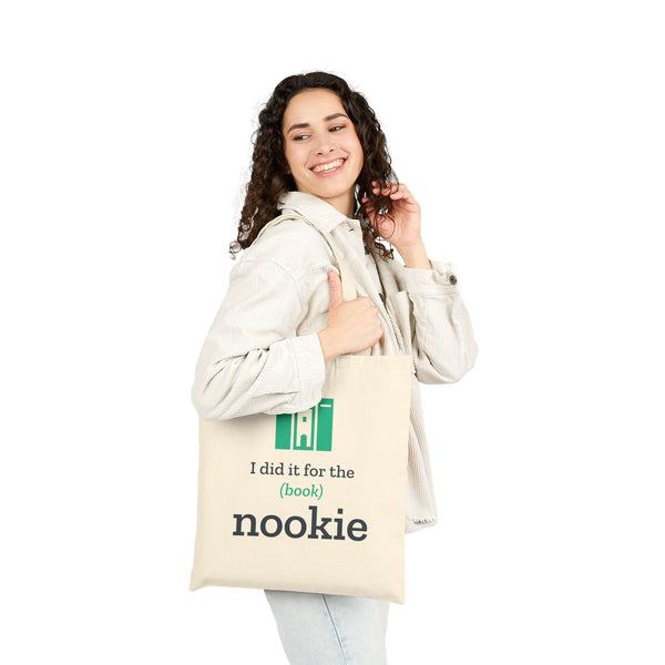 Woman carrying the natural bookish tote bag by the handles