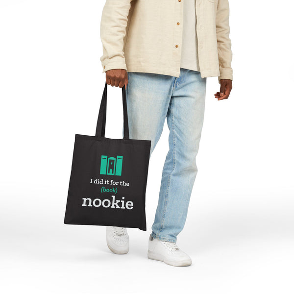 Black canvas book tote carried at the side, hanging from the 20 inch handles