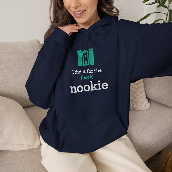 Woman on a couch wearing the navy Nook & Things bookish hoodie