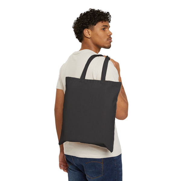 Black canvas tote bag worn over the shoulder, showing the 15 by 16 inch size