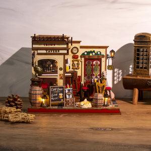 Nook & Things Crown Tavern DIY miniature kit, on a desk with books