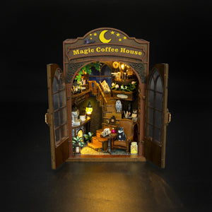 Nook & Things Magic Coffee House DIY book nook kit, lit up on a dark background