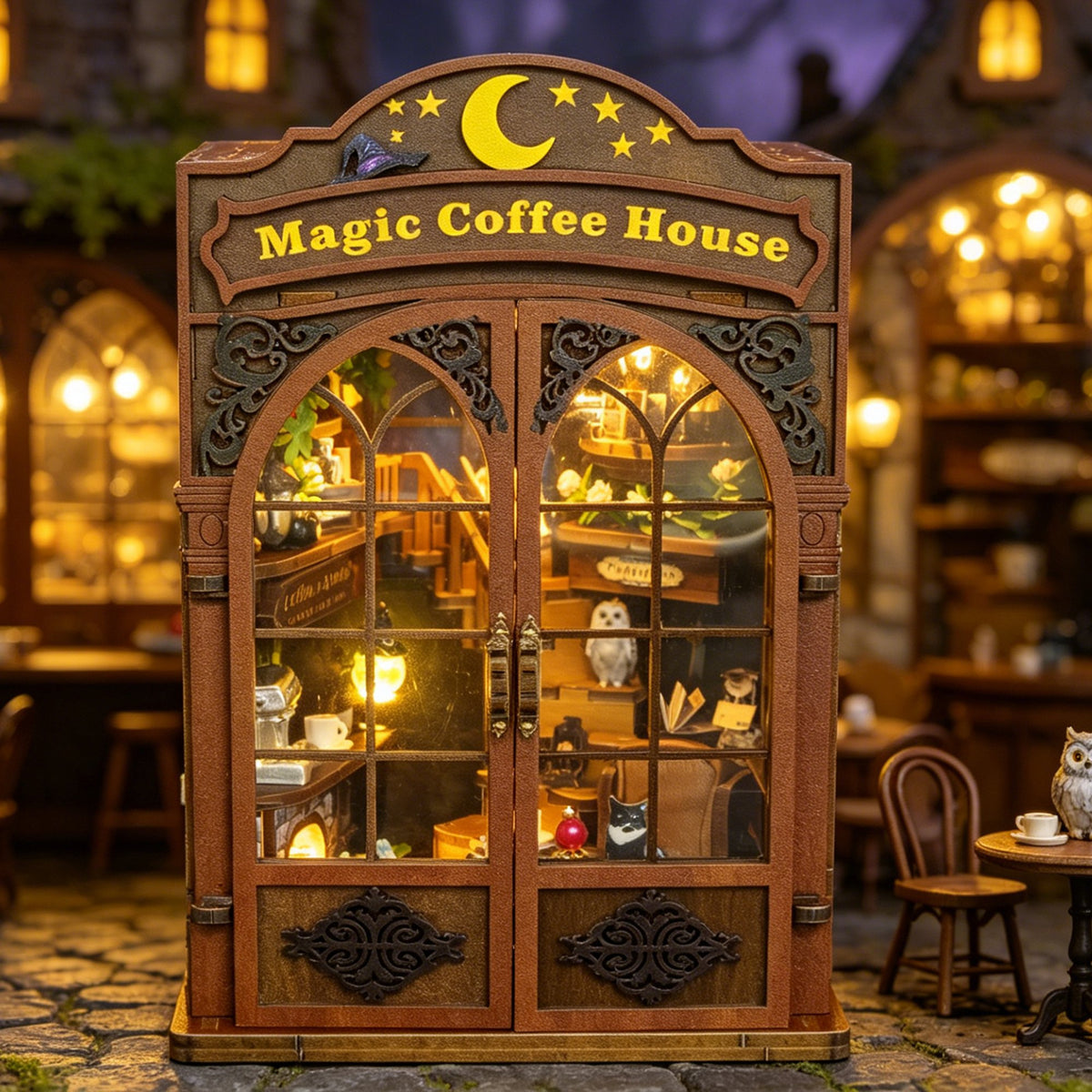 Nook & Things Magic Coffee House DIY book nook kit, glowing in a miniature street scene