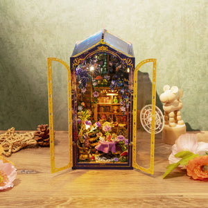 Nook & Things Magic Garden Workshop DIY miniature kit, on a wooden table with the doors open
