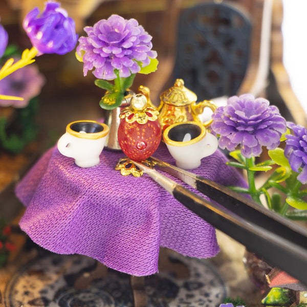 Nook & Things Magic Garden Workshop DIY miniature kit, placing a tiny cup with tweezers