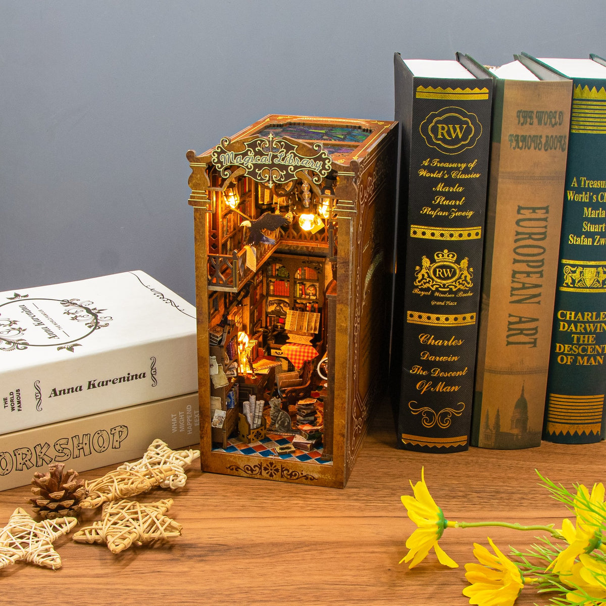 Nook & Things Magical Library book nook lit up between books on a shelf