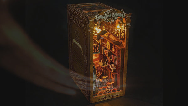Nook & Things Magical Library book nook kit glowing between books on a shelf